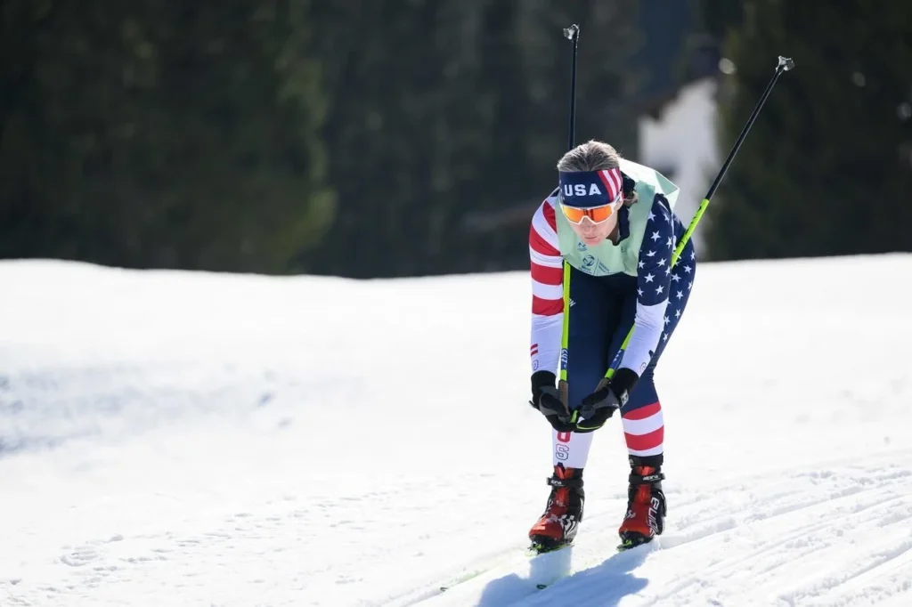 A woman skies wearing a full body USA outfit